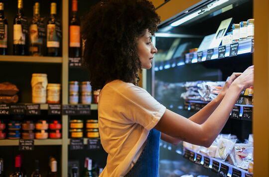 Woman working at shelf in a store